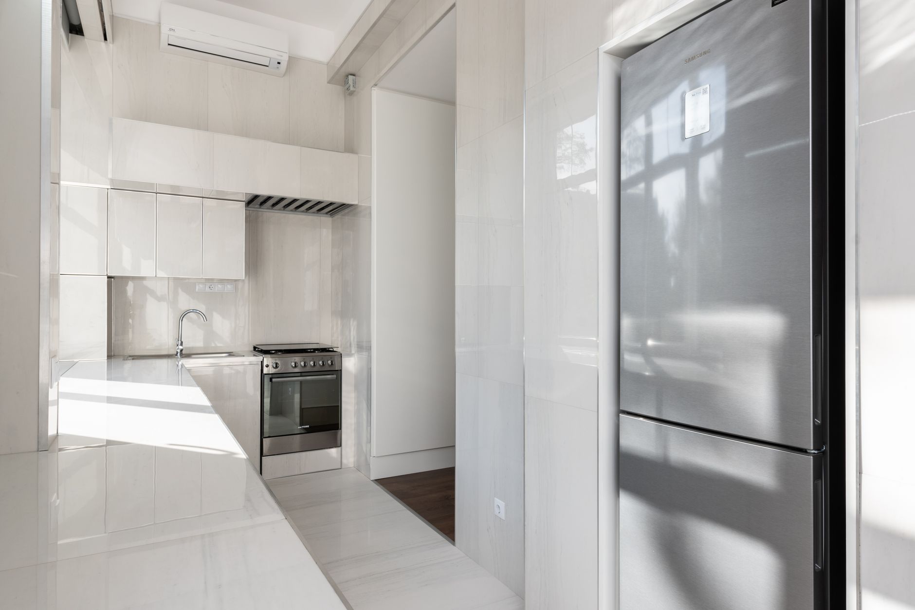 Bright and sleek modern kitchen with stainless steel appliances and minimalist design.