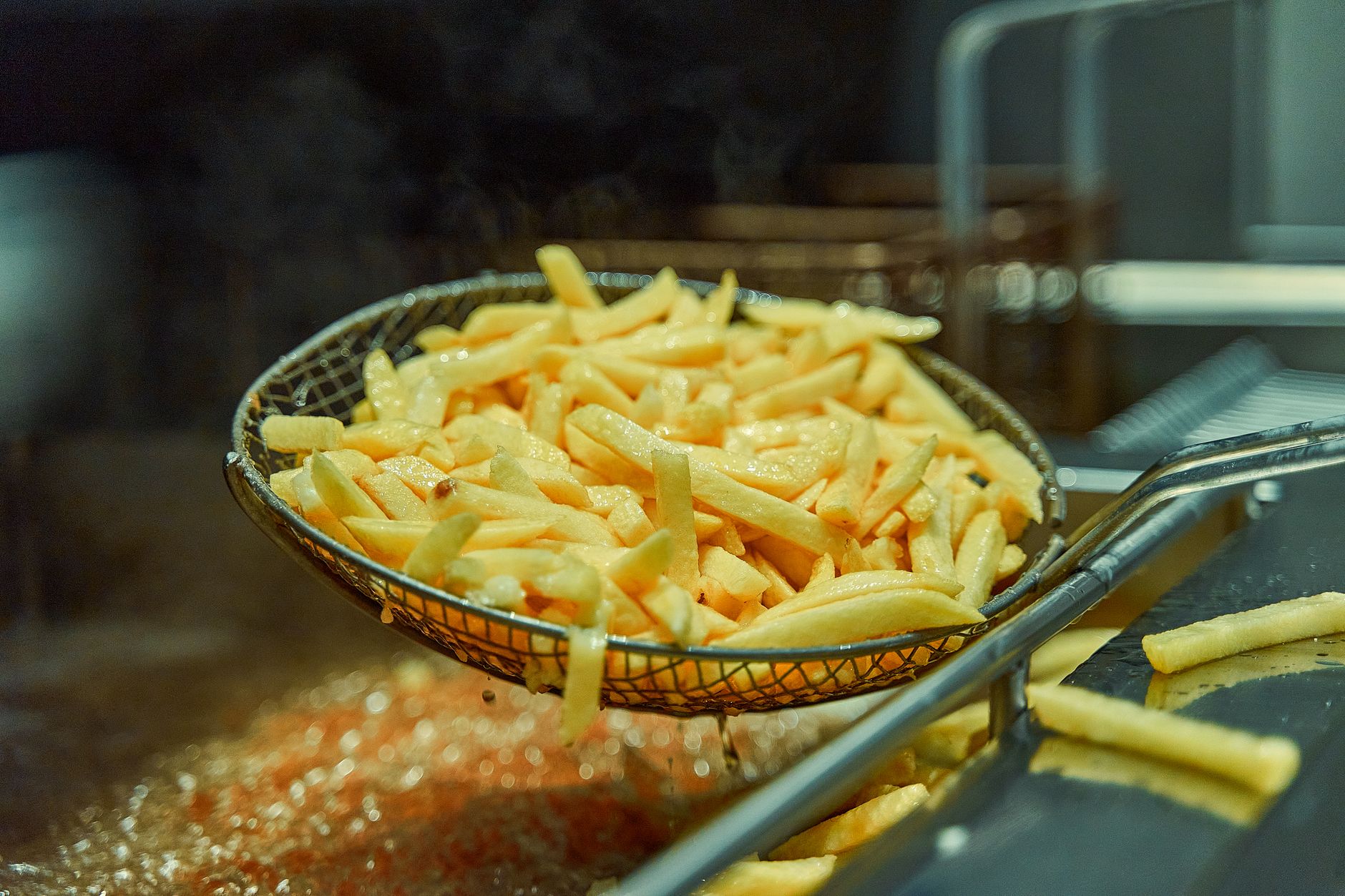Crispy golden french fries fresh from the deep fryer, ready to eat and indulge.