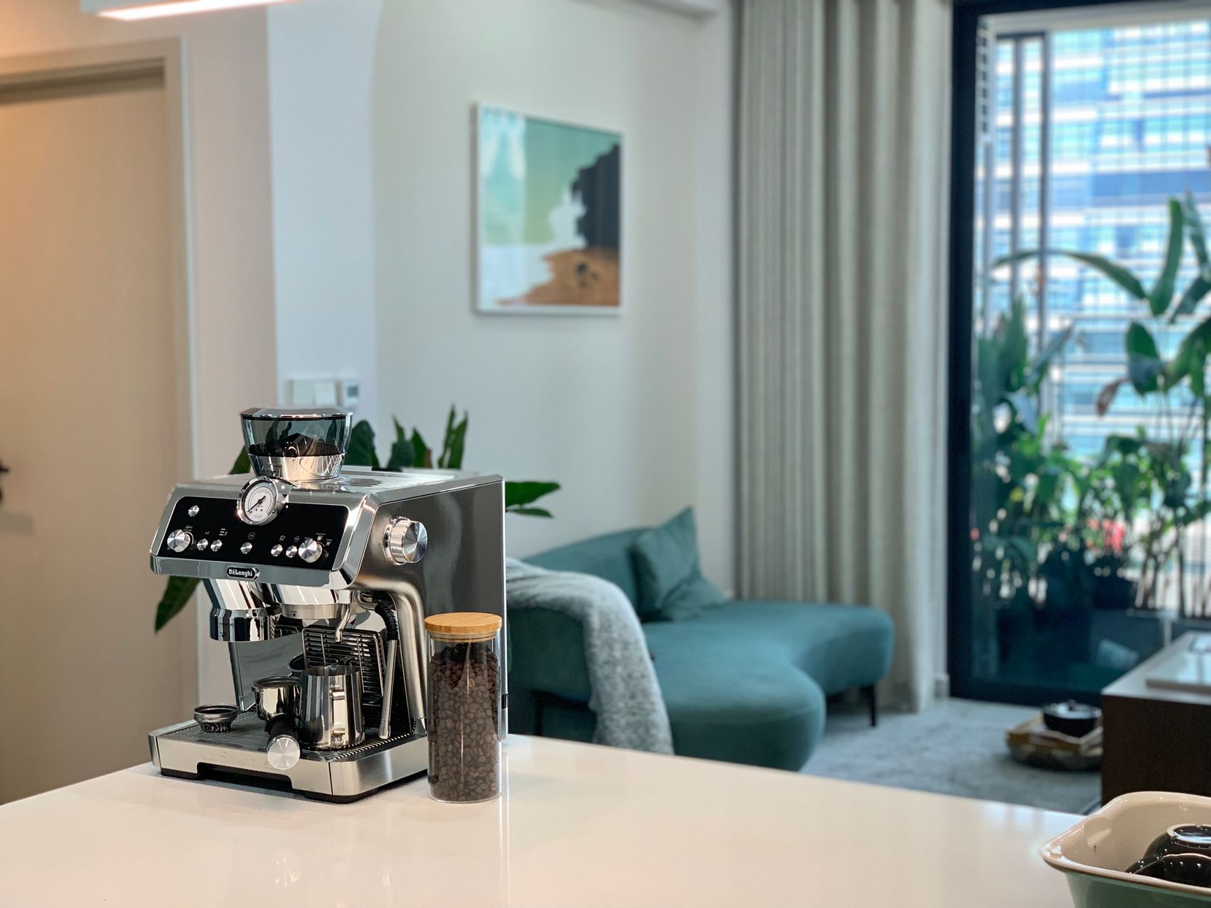Elegant kitchen interior featuring a sleek espresso machine and coffee beans jar.