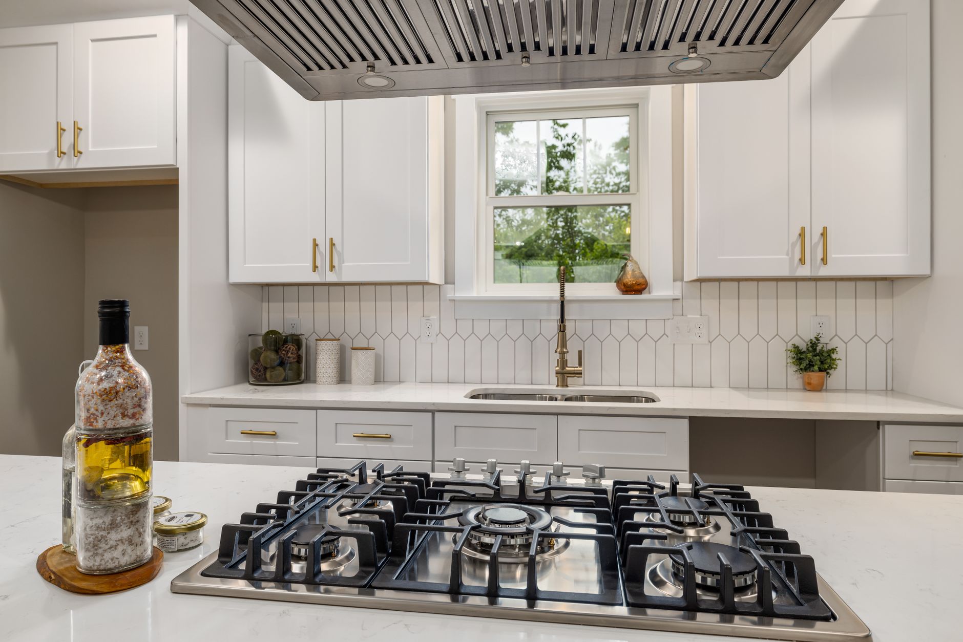 Contemporary kitchen interior showcasing a sleek gas stove and bright cabinetry, perfect for home design inspiration.