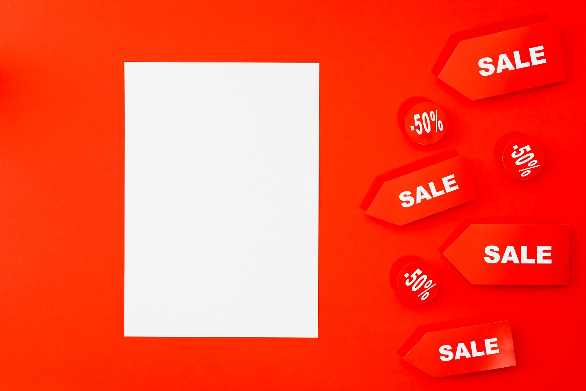 Bright red background with sale and 50% off tags, perfect for holiday promotions.