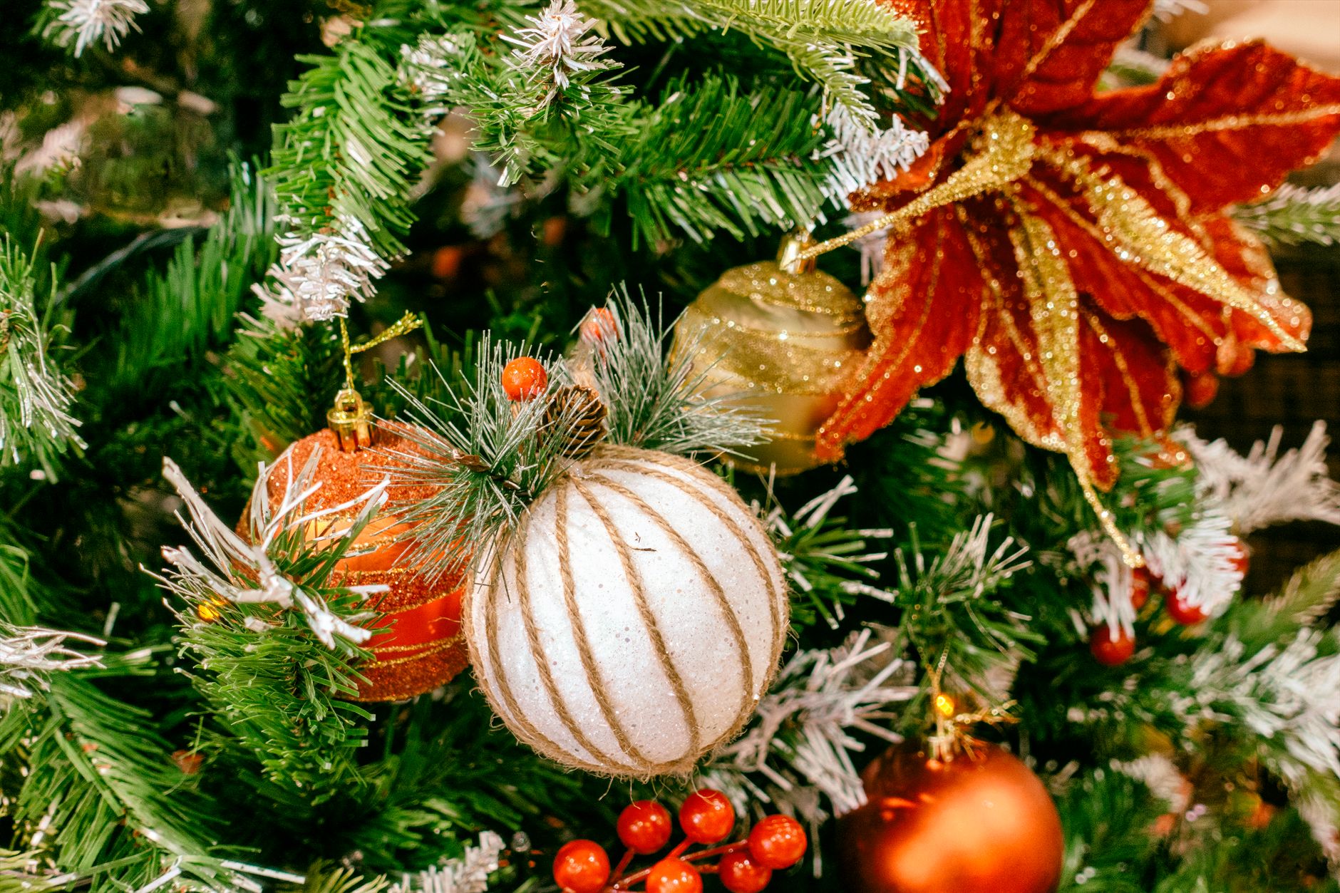 Close-up of colorful Christmas tree ornaments and decorations creating a festive holiday atmosphere.