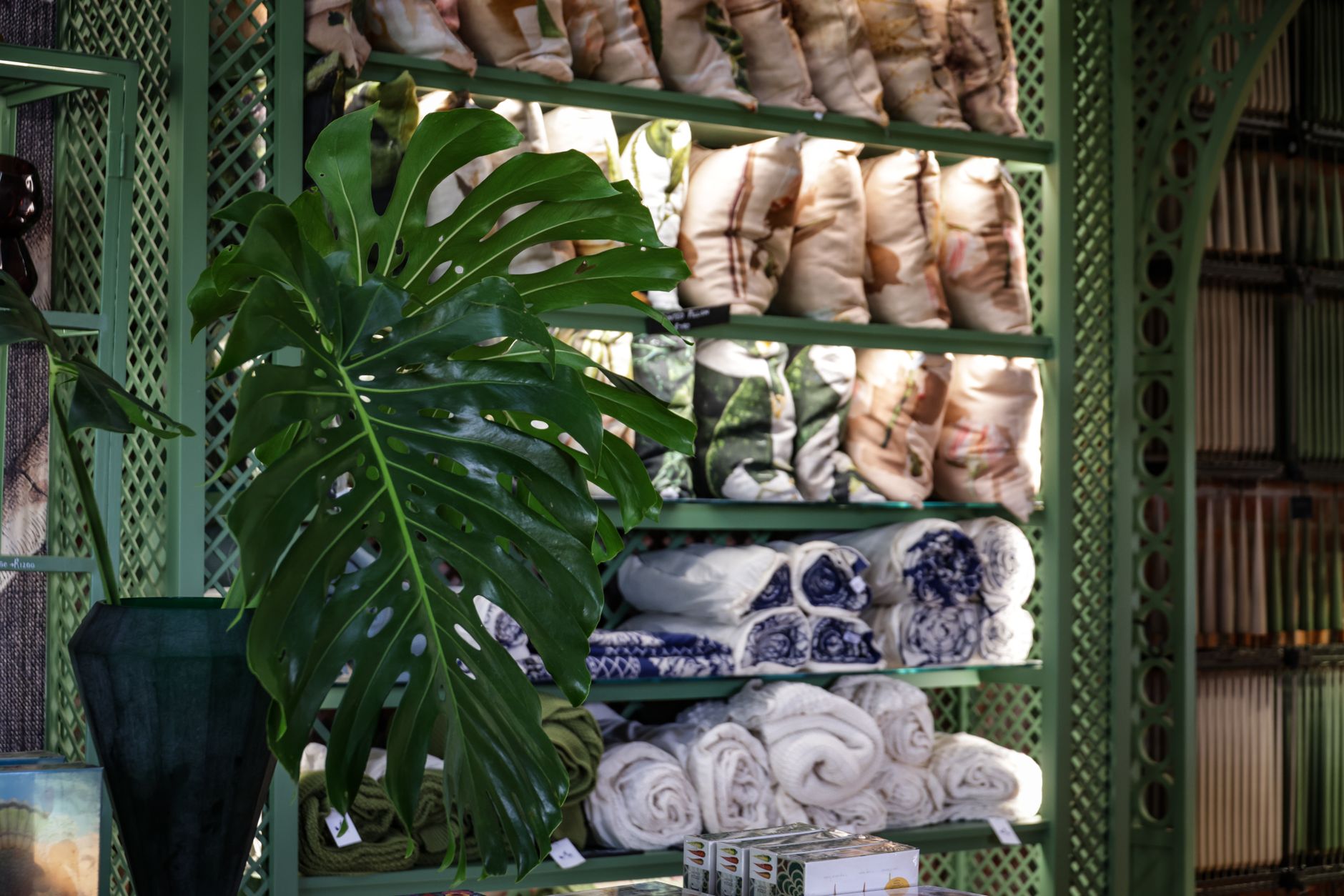 Luxurious store interior featuring green decor and elegant textile display.