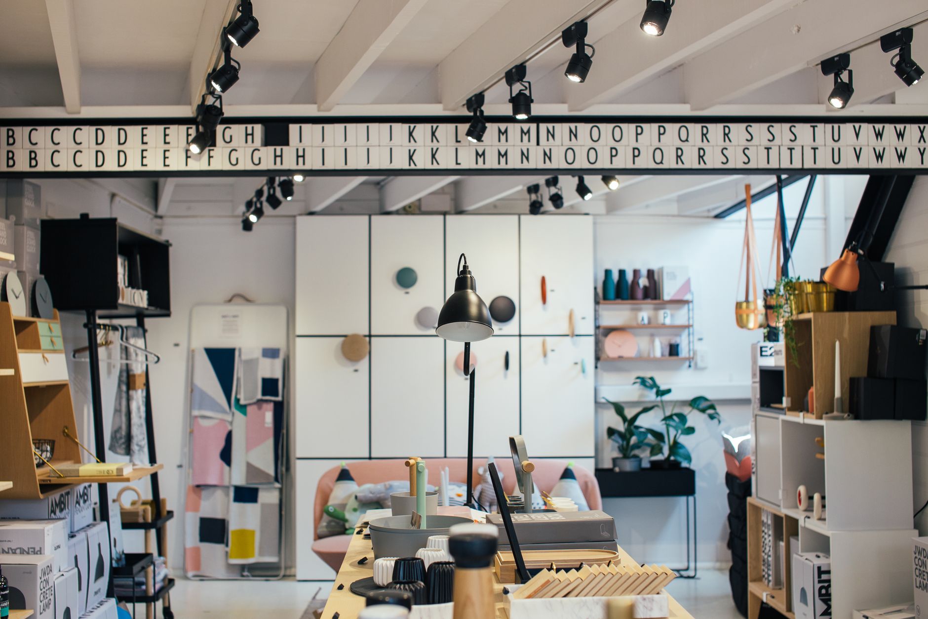 Various home goods and gifts with wooden shelves and containers in modern creative store