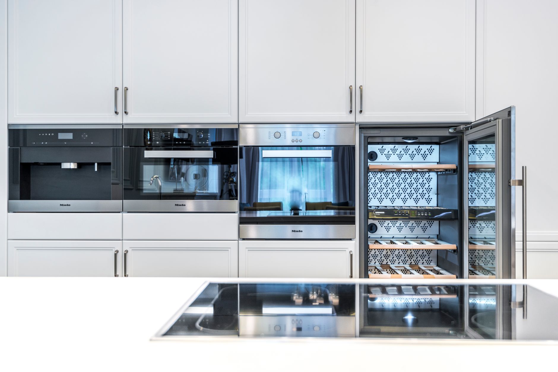 Elegant kitchen showcasing built-in appliances and minimalist design.